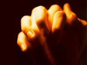 praying with hands folded for healing